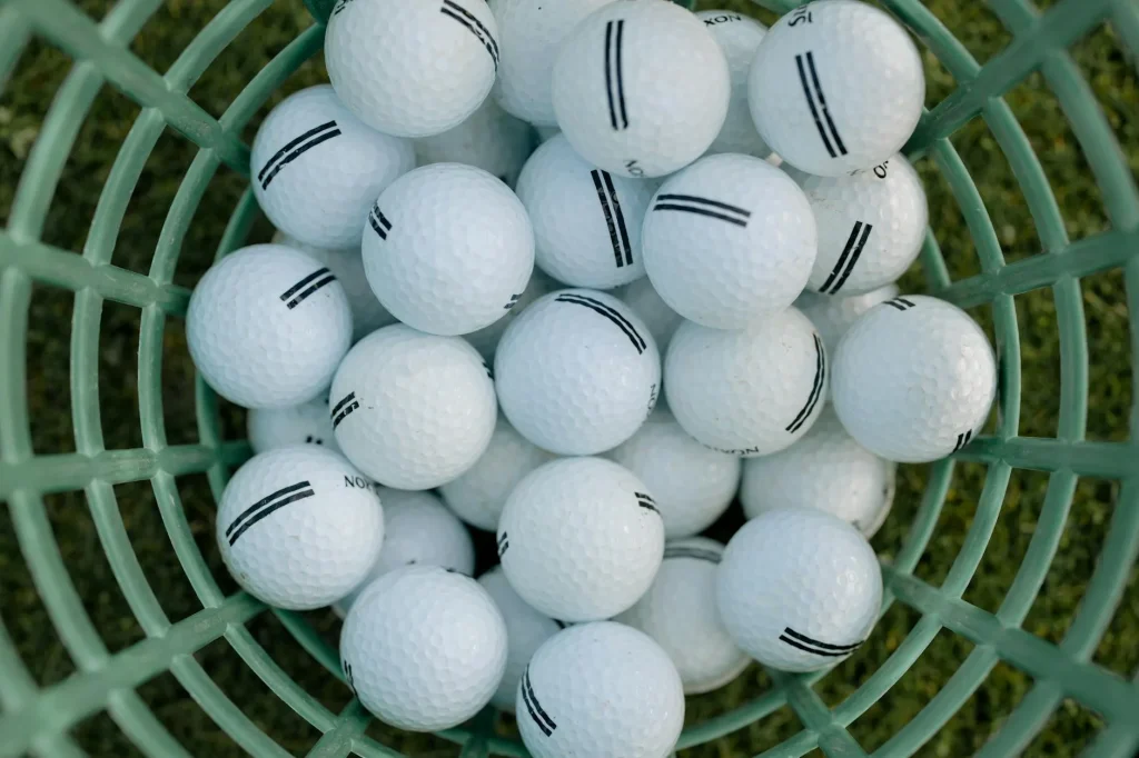 Golfer practising at driving range with launch monitor