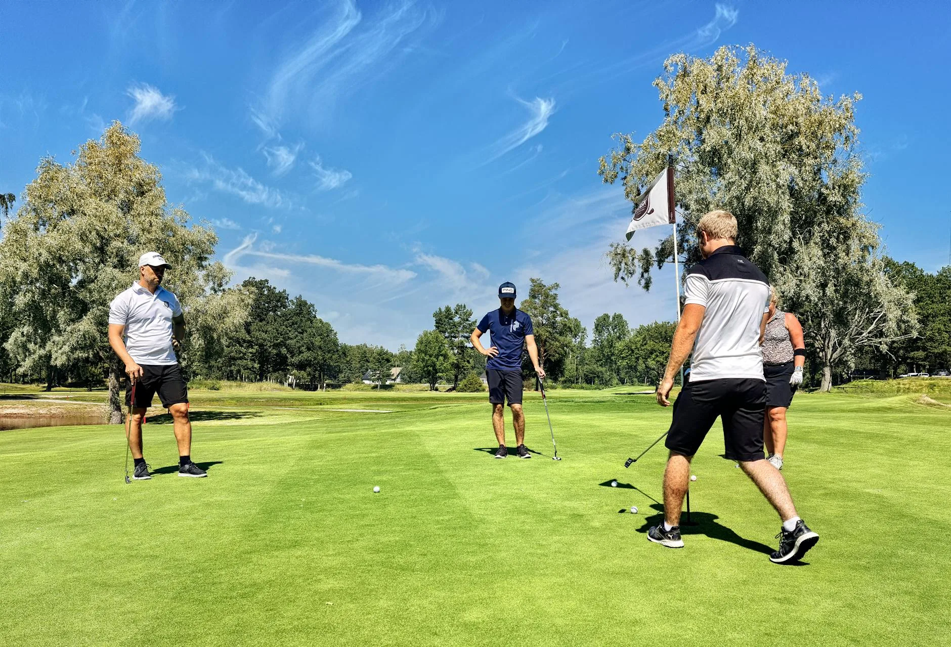 Golfer putting on the green towards the hole