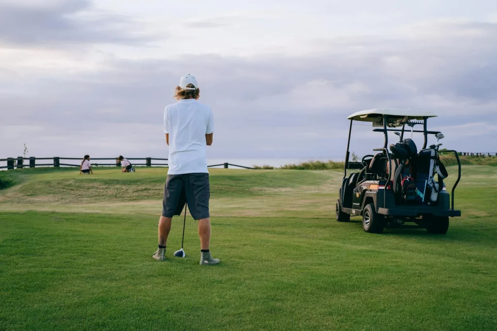 Golf bag with clubs standing on a fairway
