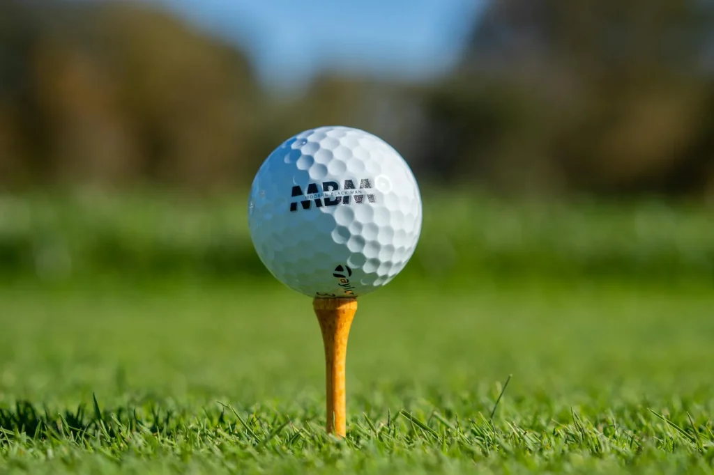 Golf ball close-up on grass showing dimple pattern