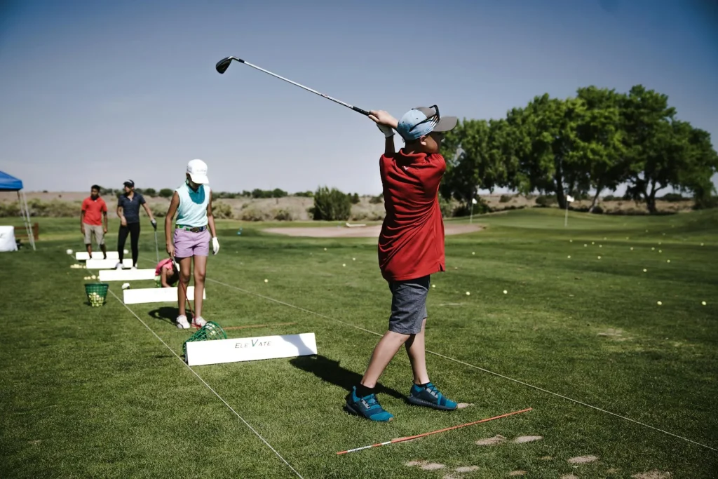Golfer practising at a driving range hitting balls