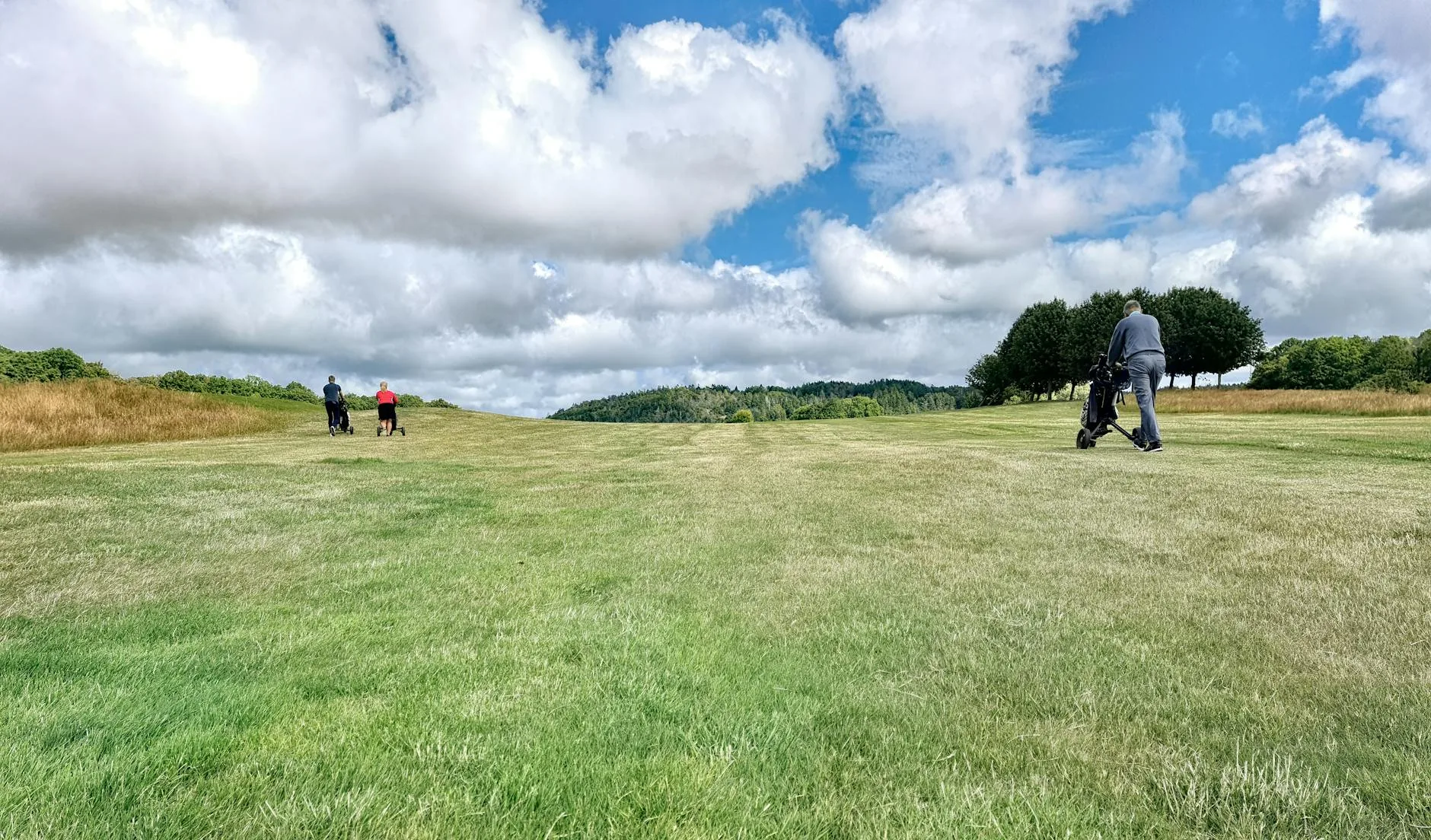 Hilly golf course path with rolling landscape