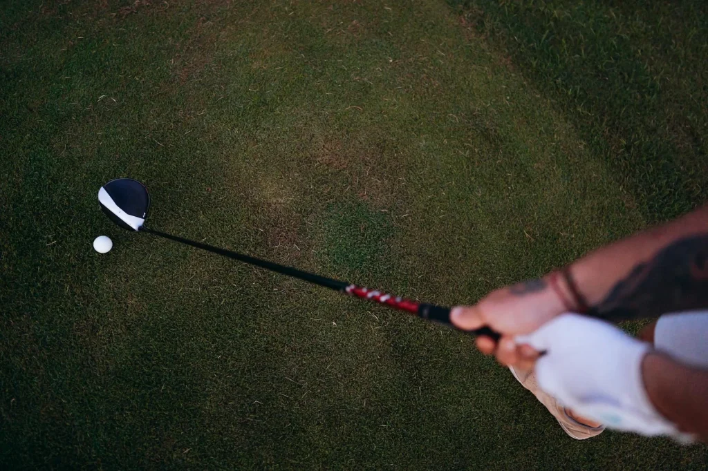 Close-up of a golfer wearing a white glove gripping a golf club