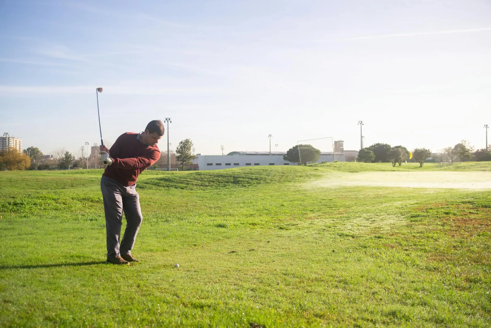 Golf iron striking the turf during a shot