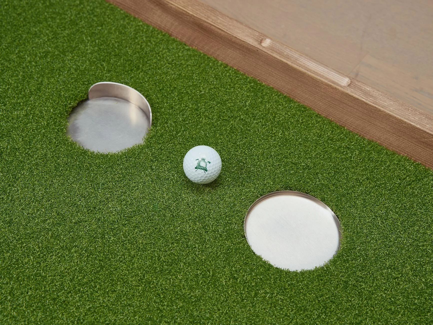 Golfer practising putting on a green