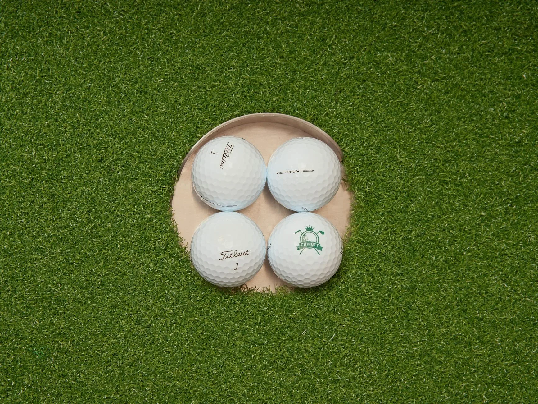 Golf putting practice on a green with balls near the hole