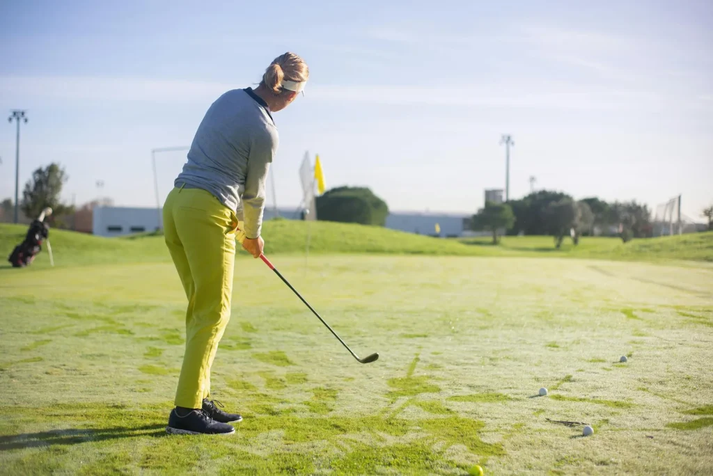 Golfer practising their swing at an outdoor driving range