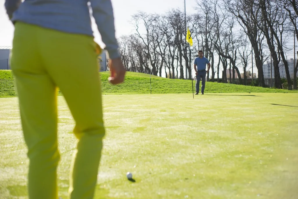 Golf ball near the hole on a putting green
