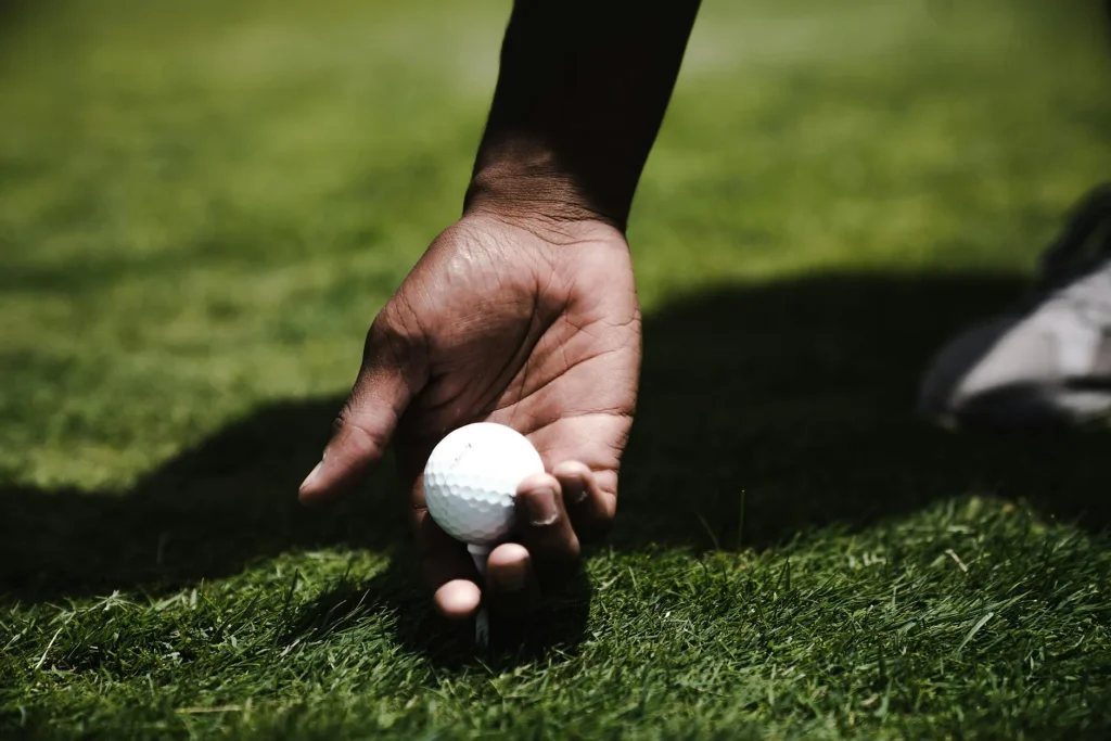 Golf balls on a tee on a green golf course