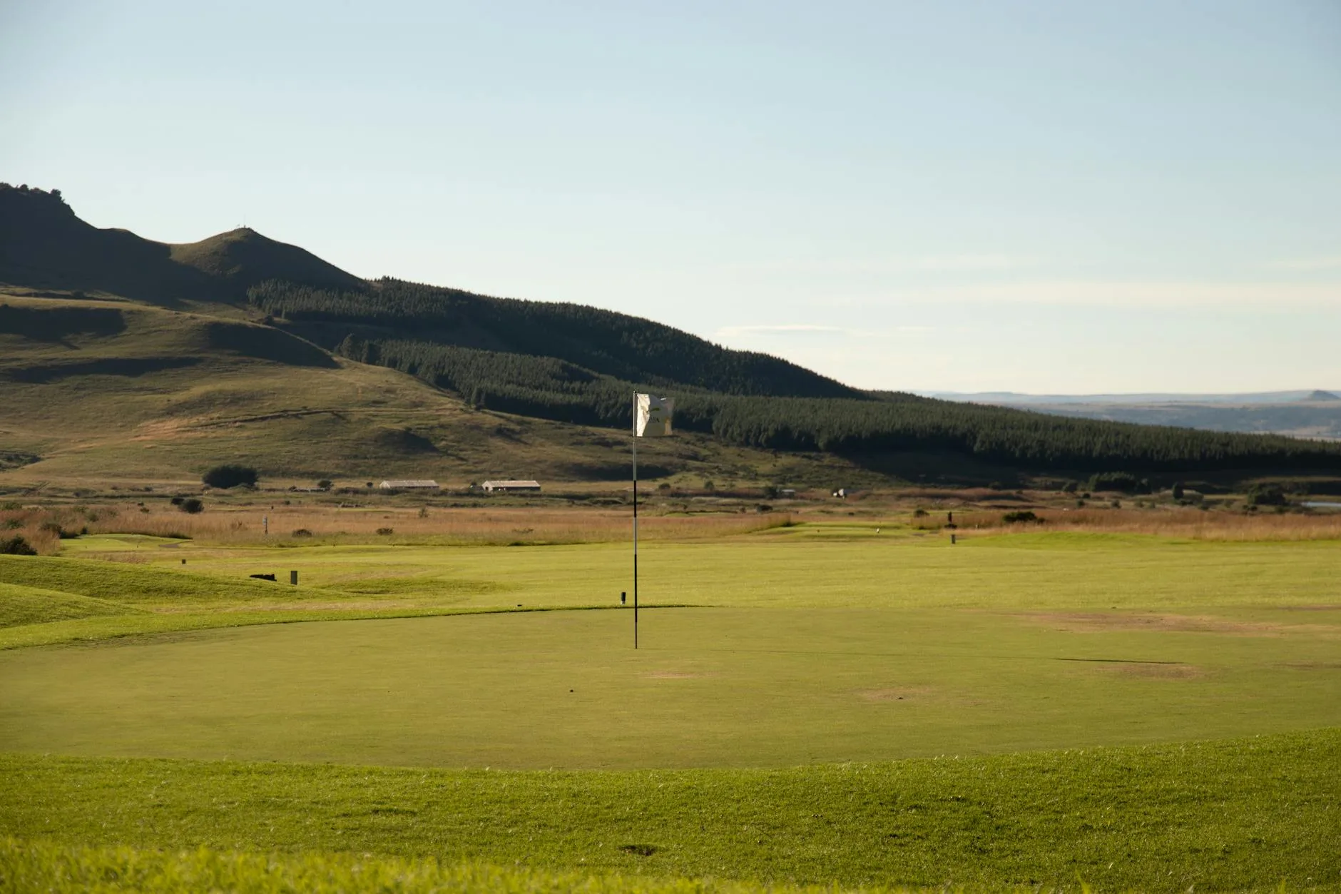 Scenic golf course with green hills and landscape
