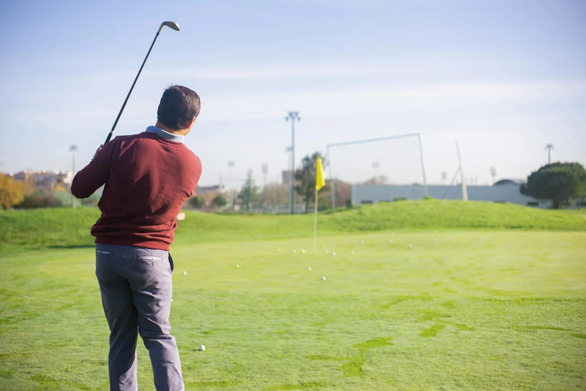 Golfer taking practice swings on the driving range