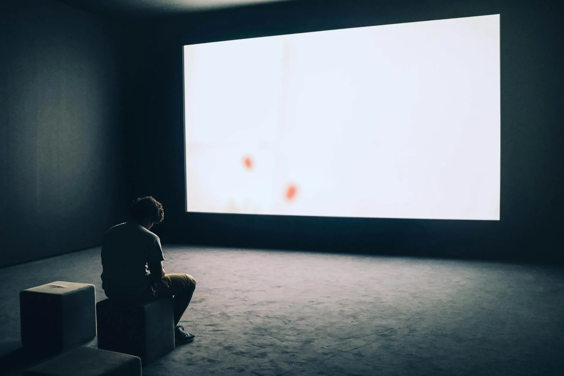 Projector displaying onto a screen in a home setup