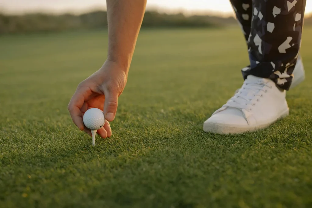 Golf ball on a tee ready for a practice swing