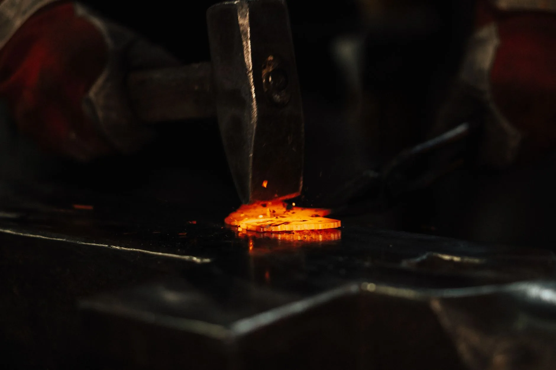 Forged golf iron steel being shaped in a metal workshop